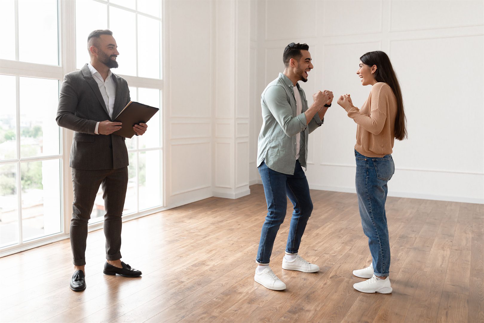 excited-couple-buying-new-apartment-celebrating