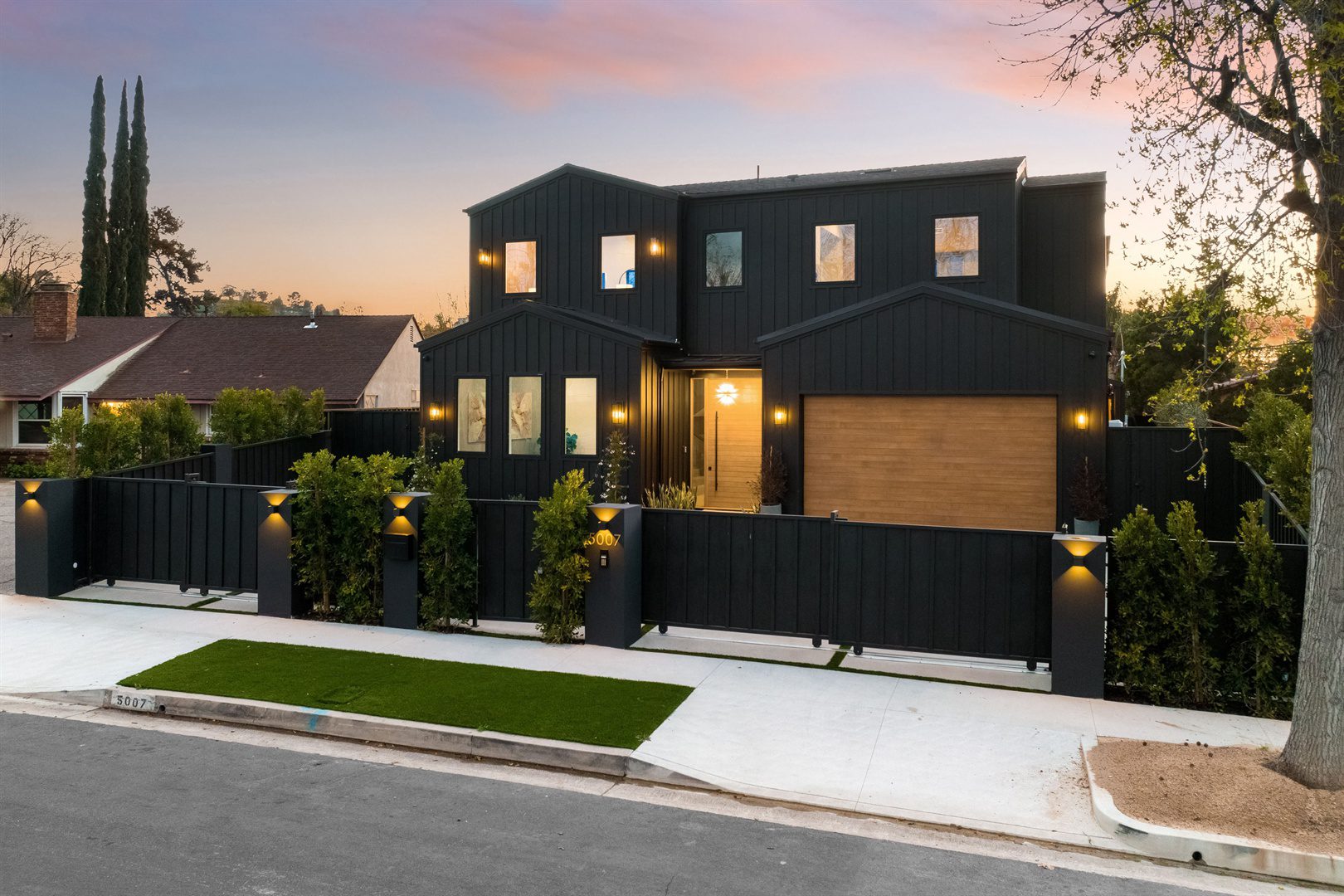 modern-black-house-with-wooden-accents-at-sunset