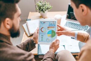 two-analysts-or-economists-holding-touchpad