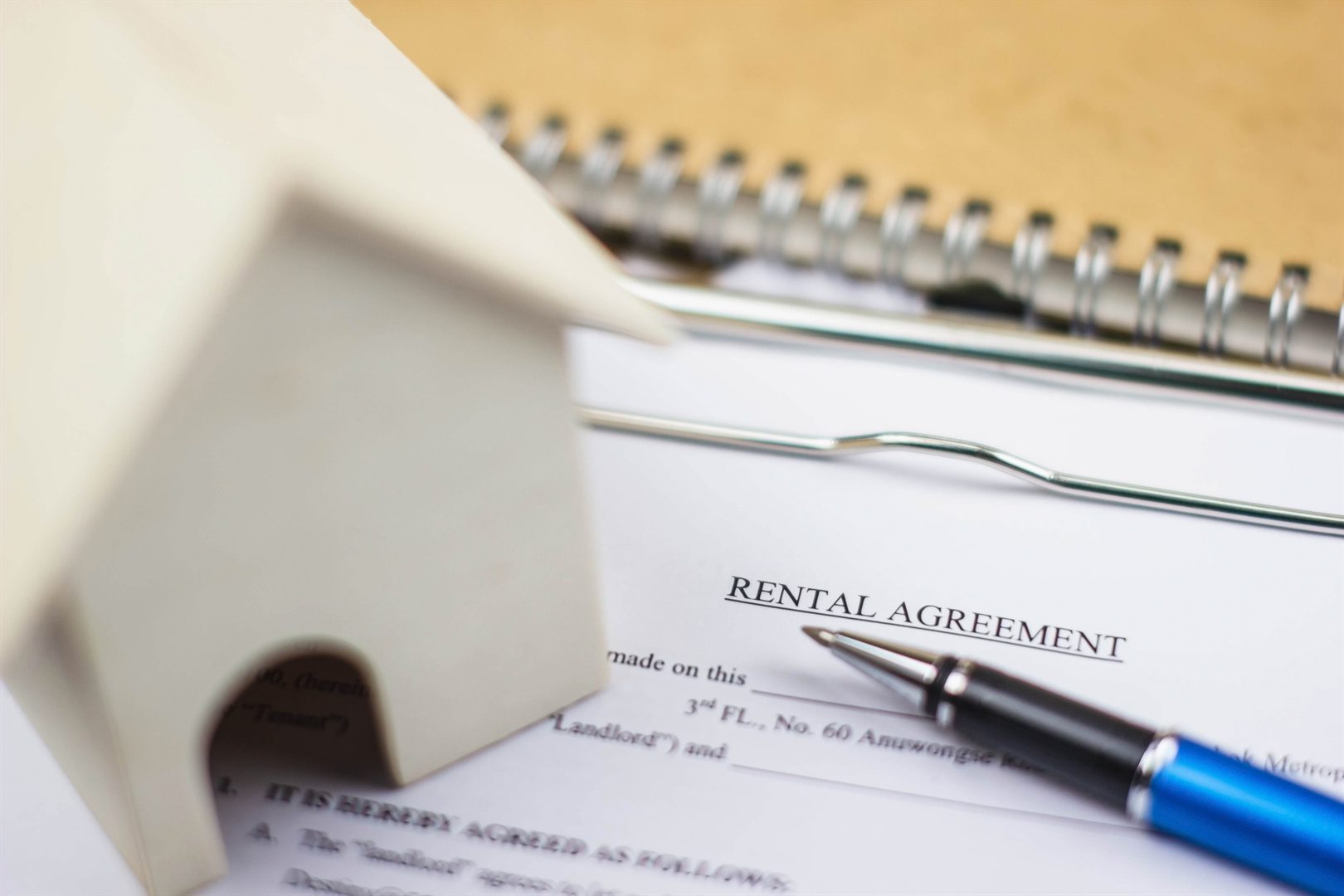 home-model-and-rental-agreement-document-with-pen