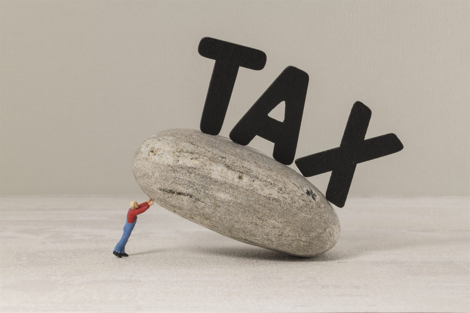 man-collapses-under-the-tax-burden