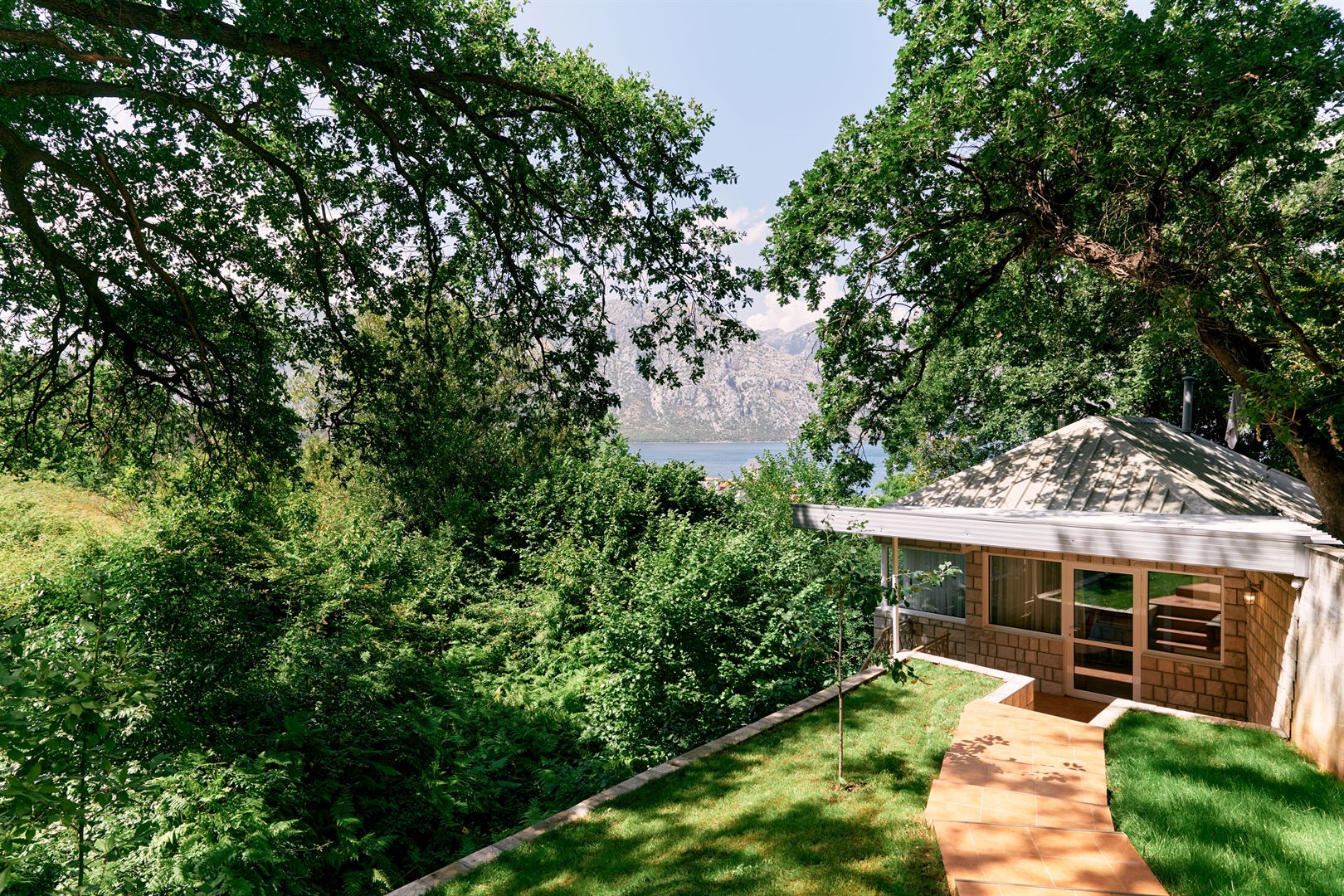 paved-path-to-a-brick-gazebo-in-a-green-garden