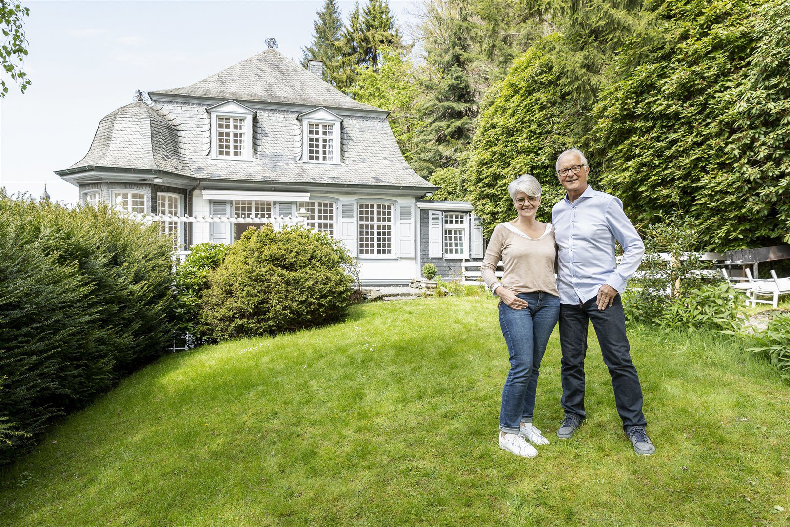 smiling-senior-couple-standing-in-garden