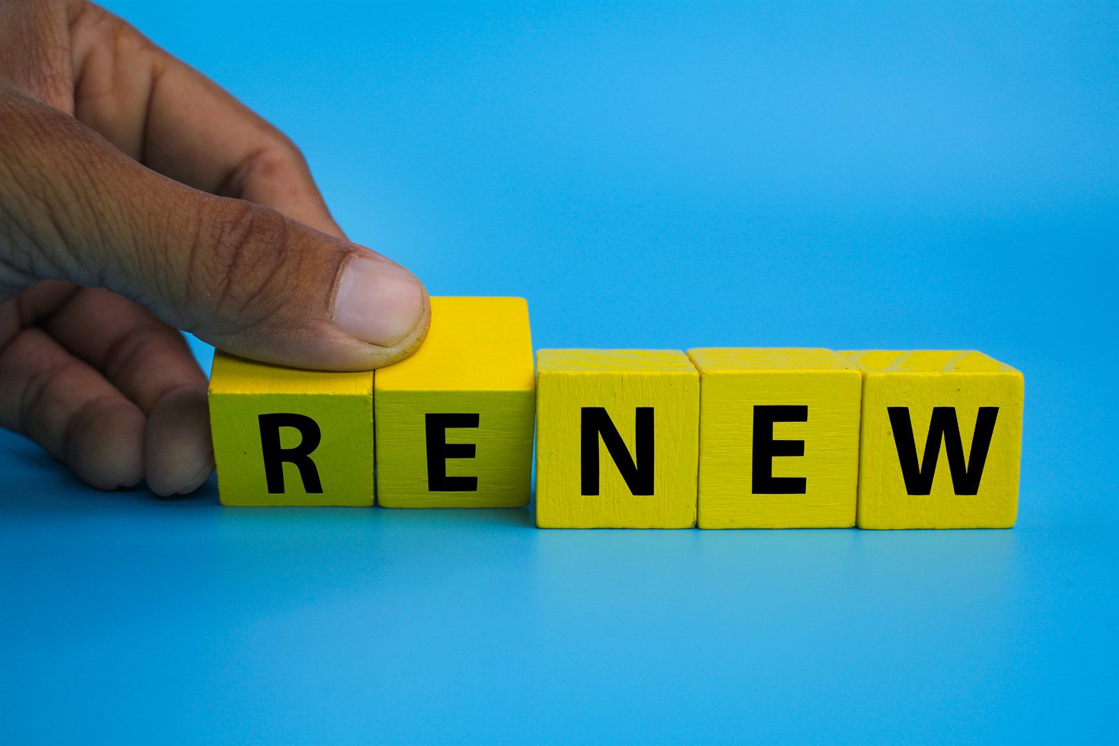 yellow-wooden-cube-with-the-word-renew-time