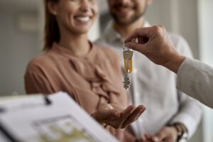 close-up-of-couple-receiving-new-house-keys