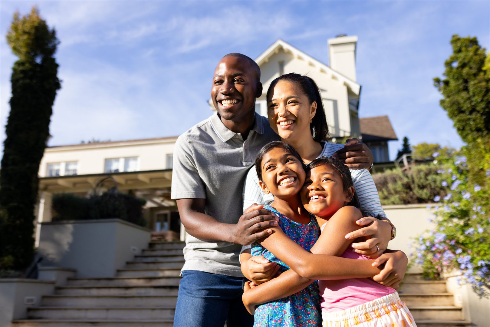 outdoors-happy-biracial-family-of-four-is-smiling